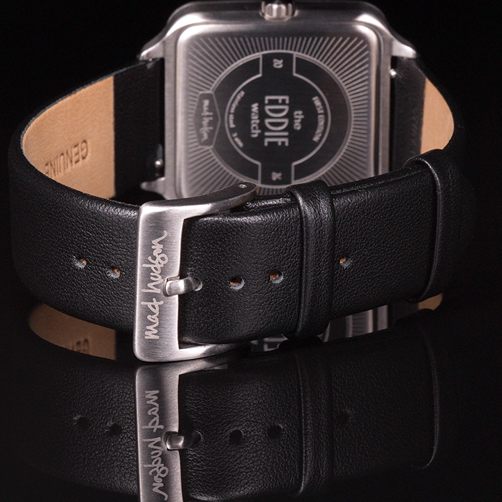 Eddie Wristwatch stainless steel case and black leather strap, stainless steel buckle against a black background mad hudson watches