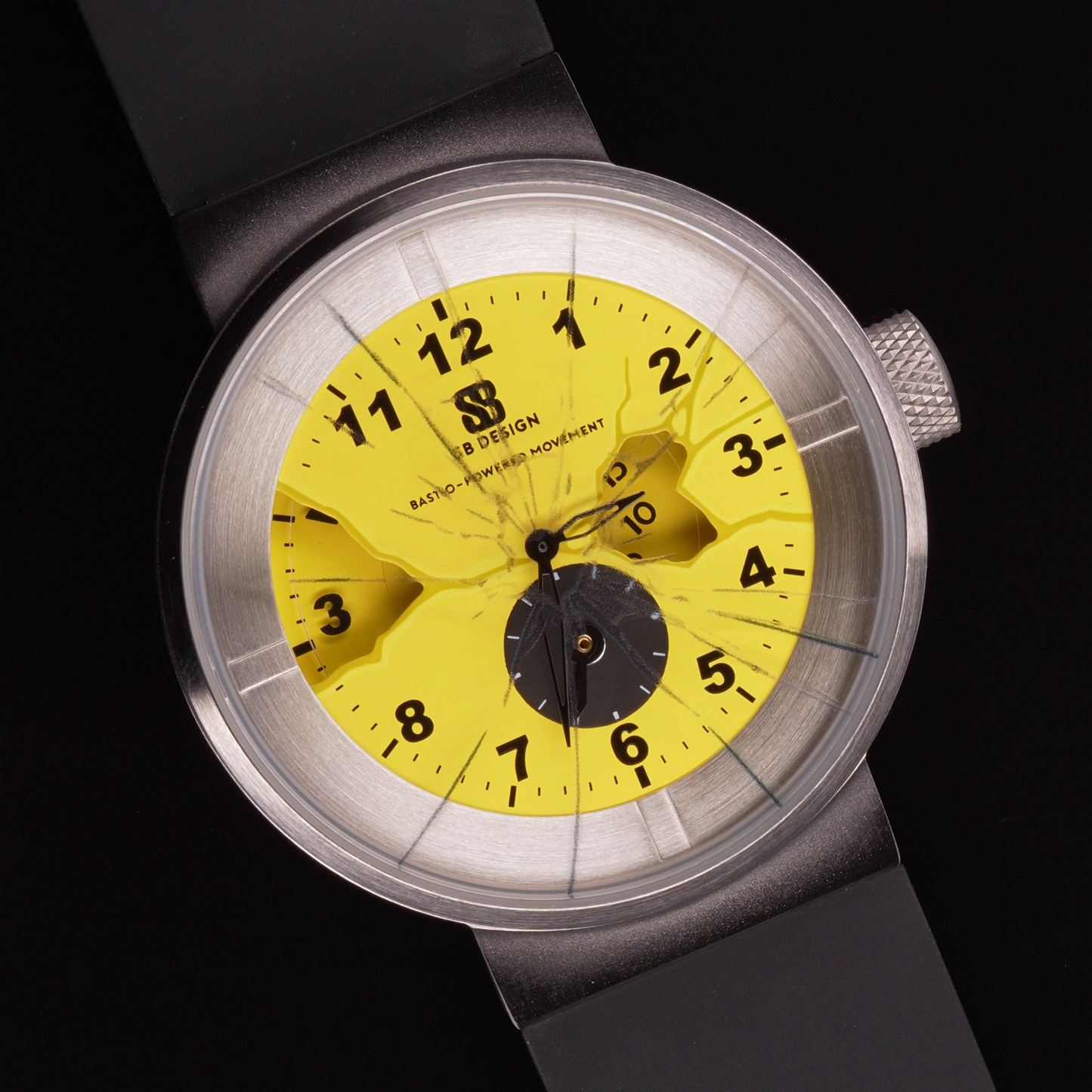 Wristwatch with yellow dial and black numbers glass painted to look as if it is cracked and a stainless steel case on a black background Broken Time Watch Brad Podray Mad Hudson