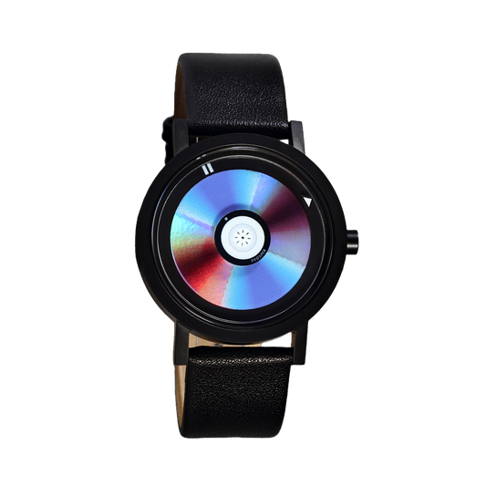 Wristwatch that looks like a CD with a blue red and iridescent face with a black stainless steel case and black leather strap on a white background CD Watch Riki Prosper Mad Hudson