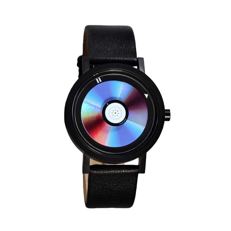 Wristwatch that looks like a CD with a blue red and iridescent face with a black stainless steel case and black leather strap on a white background CD Watch Riki Prosper Mad Hudson