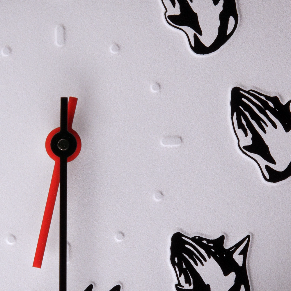 Wristwatch with a black and white face dog head and praying hands with a black minute hand red hour hand Dogma Watch Bryce Wong Mad Hudson