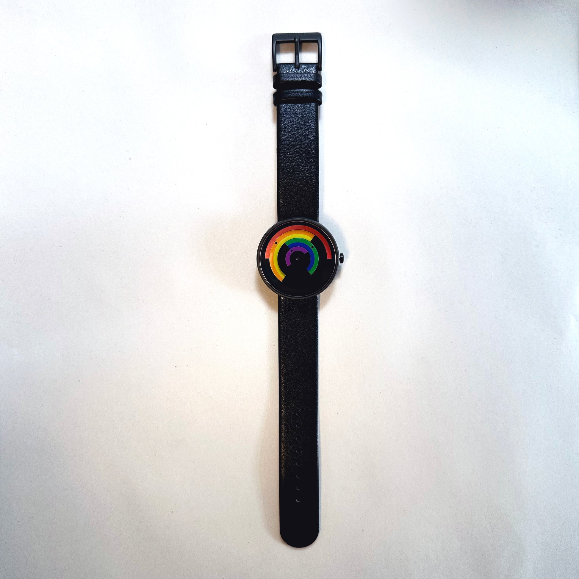 Black watch with a rainbow display on a white background