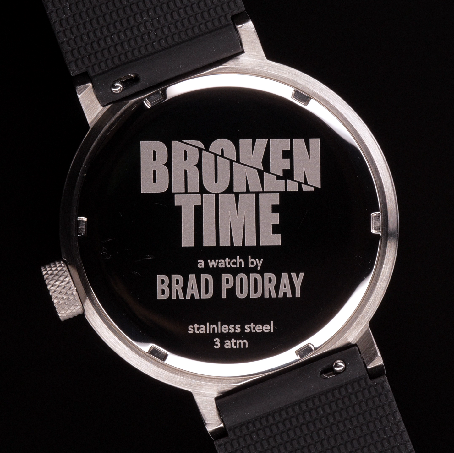 Watch with 'Broken Time' and 'Brad Podray' branding on a black background