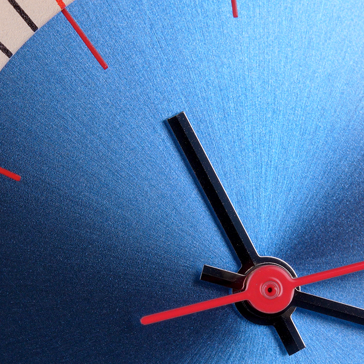 Eddie Wristwatch close up with stainless steel case and black leather strap, tan and blue face against a black background mad hudson watches