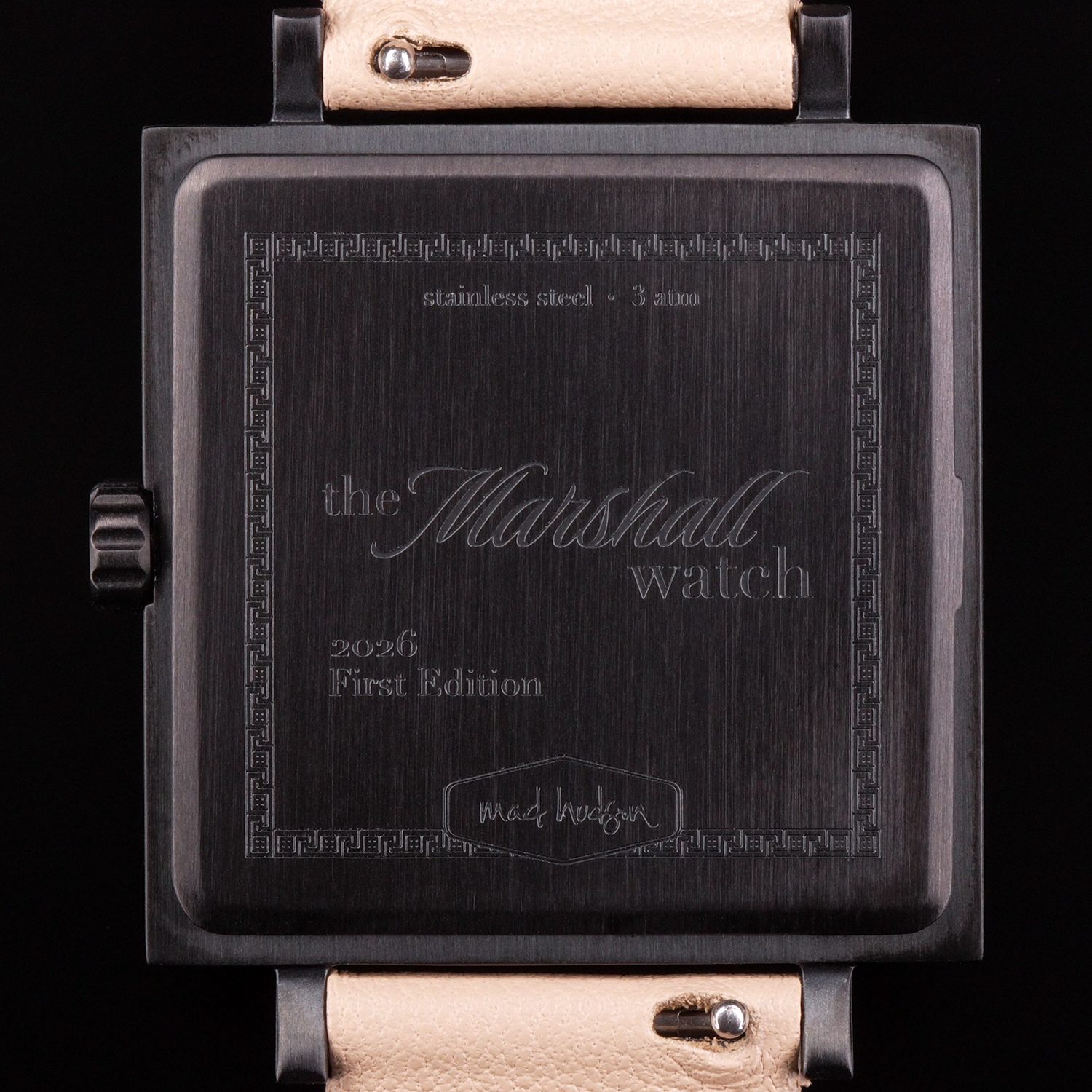 back of Marshall watch with engraved text on a black background