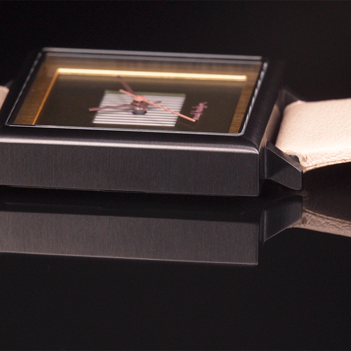 side view Square watch with green face and beige strap on a black background. Black stainless steel square case, beige leather band. Layered design with a gold frame. Engraved case back. Adjustable Strap. The Marshall Watch Mad Hudson Watches