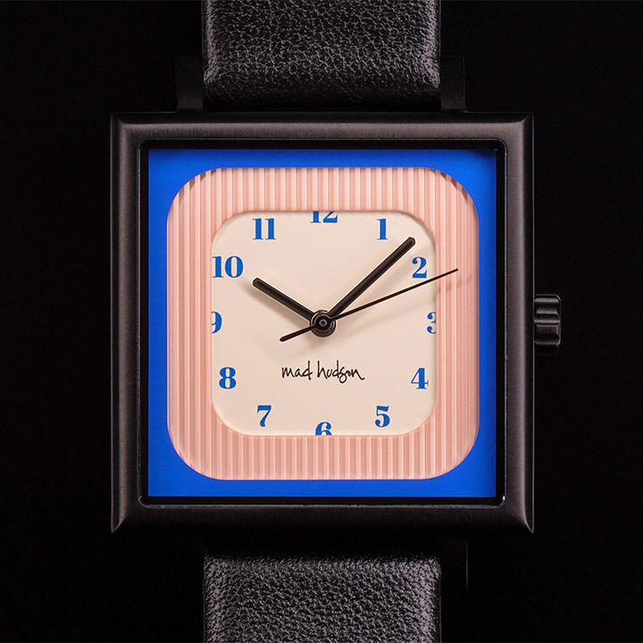 Wristwatch with a black leather strap and square case pink blue and tan face on a white background The Miami Watch Mad Hudson Watches