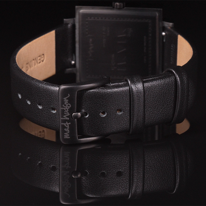 back of wristwatch Black leather band with a buckle on a dark background