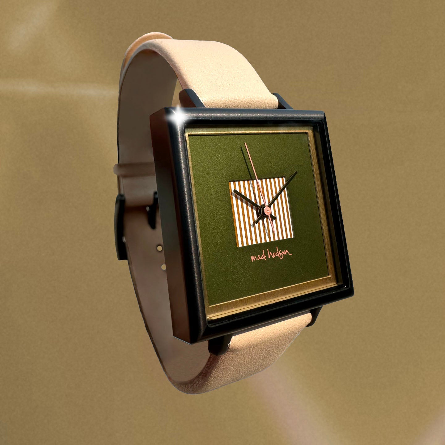 Square watch with green face and beige strap on a beige background. Black stainless steel square case, beige leather band. Layered design with a gold frame. Engraved case back. Adjustable Strap. The Marshall Watch Mad Hudson Watches